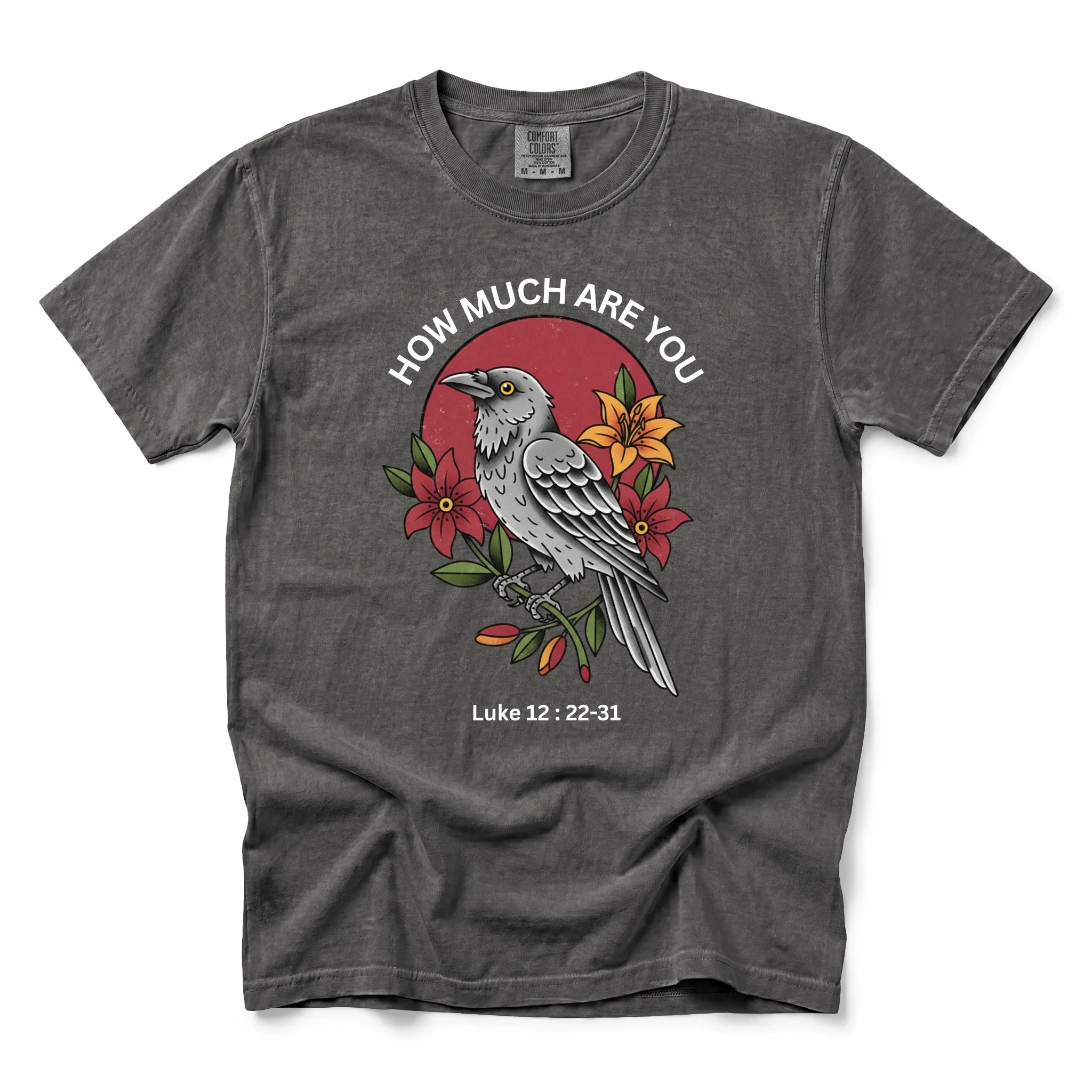A pepper short-sleeve t-shirt with a graphic print of a raven, red flowers, and the text 'HOW MUCH ARE YOU Luke 12:22-31' on a white background.